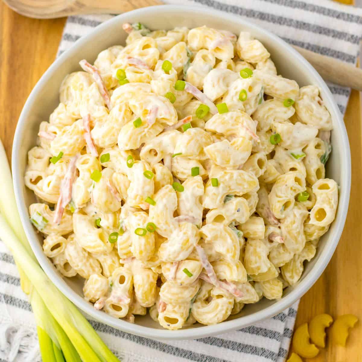 Homemade Hawaiian macaroni salad in a bowl with chopped scallions.