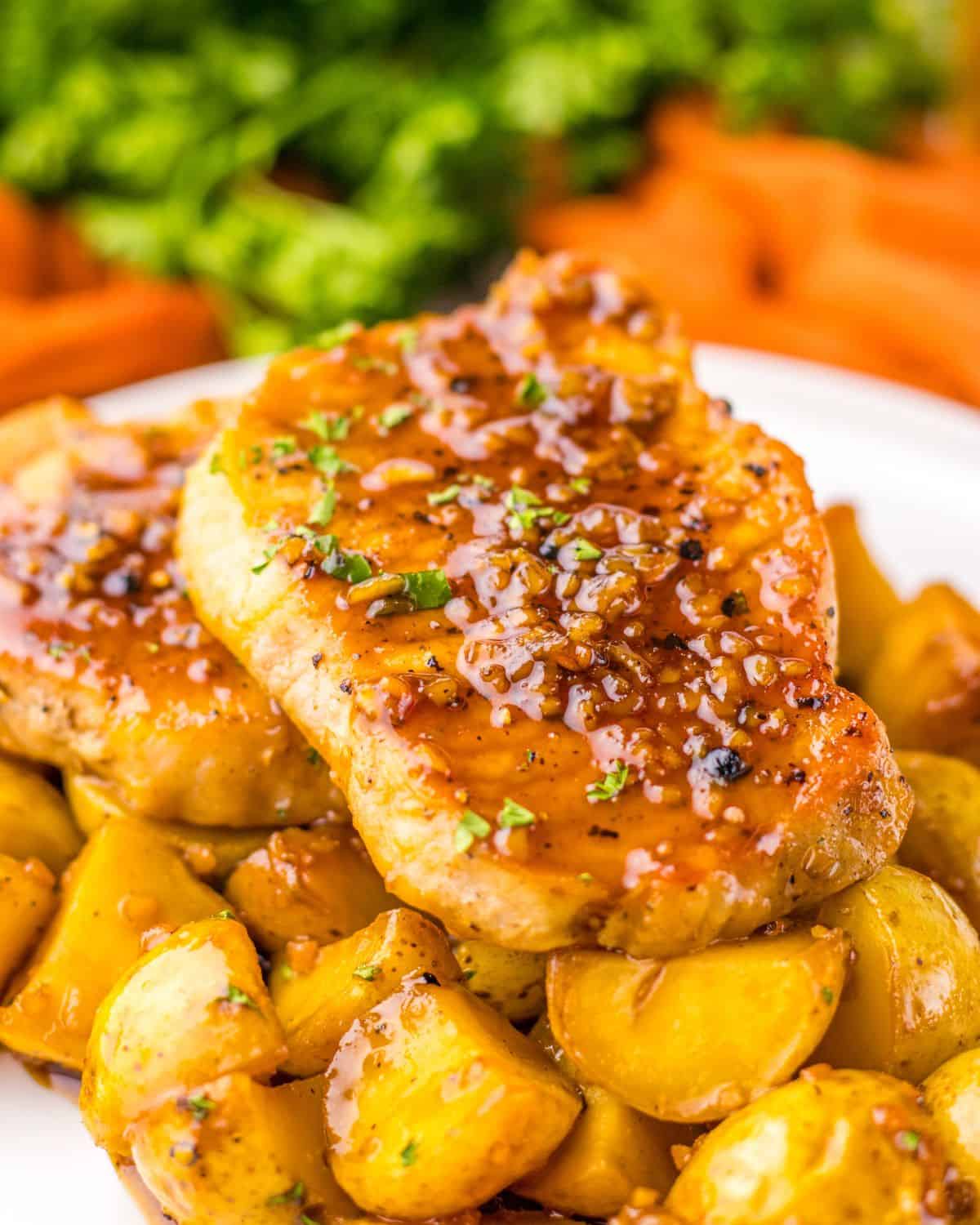 Boneless pork chops and baby potatoes in a honey garlic sauce.