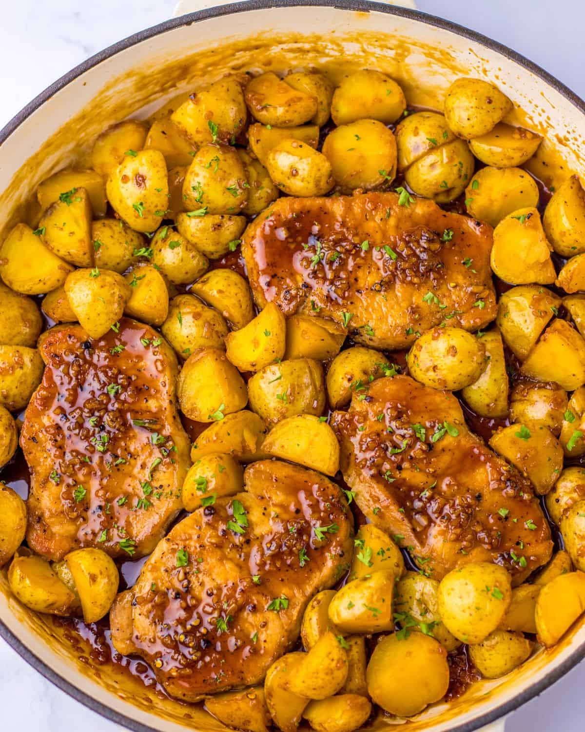 Pork chops and potatoes in a honey garlic sauce.