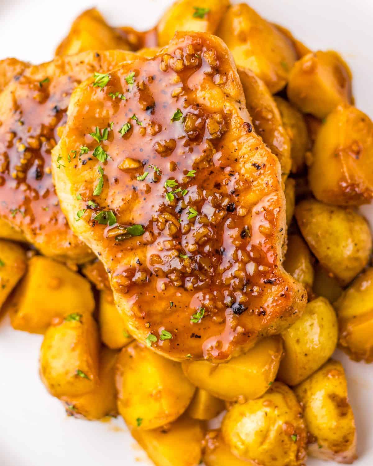 Honey garlic pork chops served over baby potatoes.
