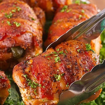 Smoked chicken thighs wrapped in bacon and stuffed with jalapeno popper filling.