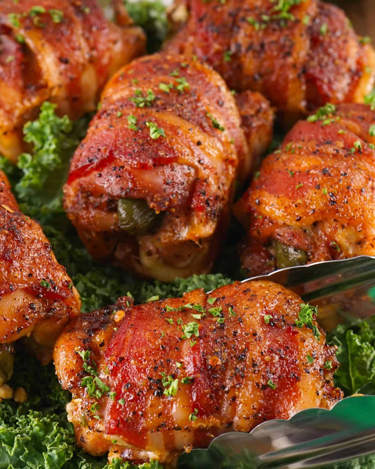 Smoked chicken thighs with japaleno popper filling and wraooed with bacon.