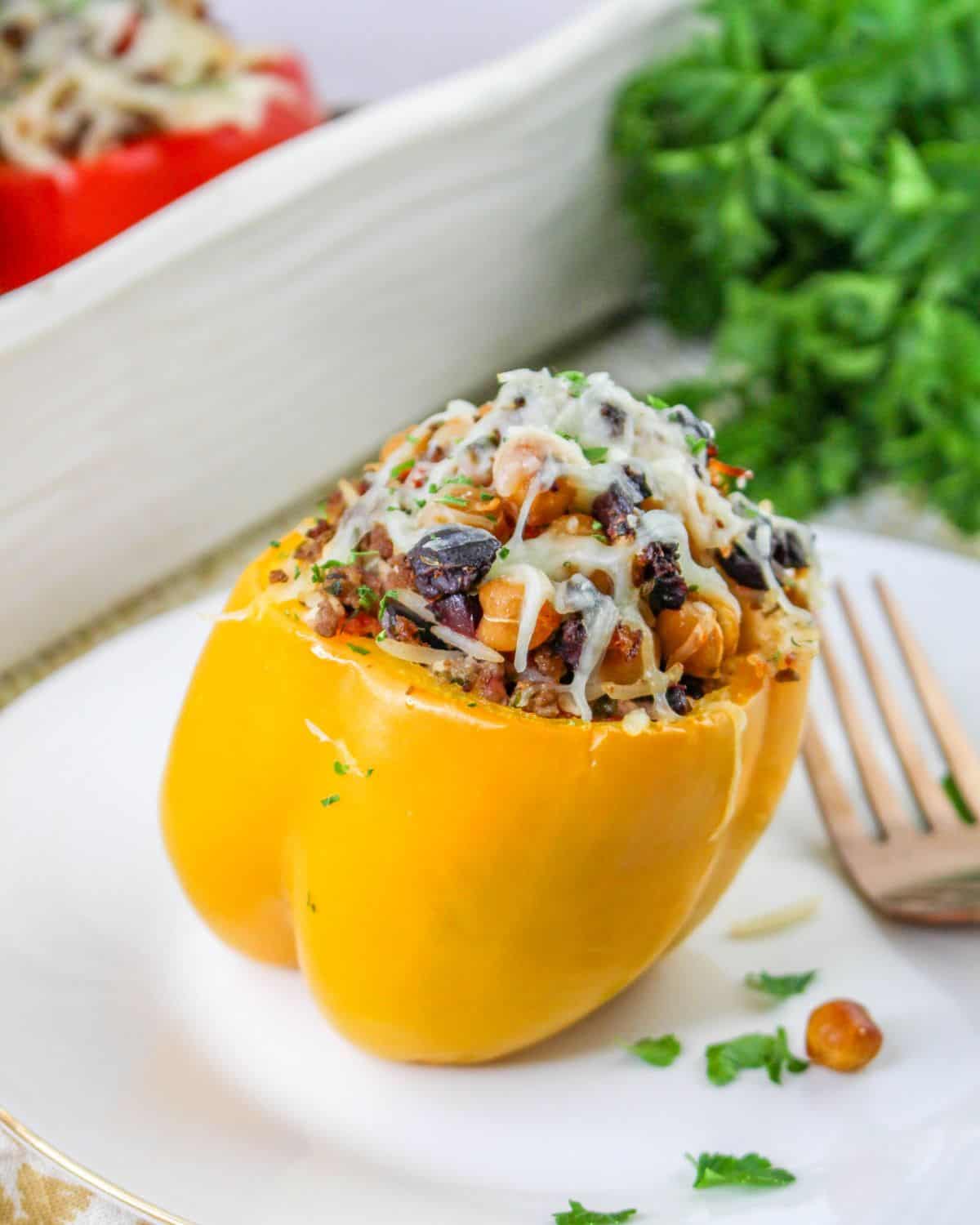 Mediterranean stuffed peppers with chickpeas, ground beef, roasted peppers, and rice. 