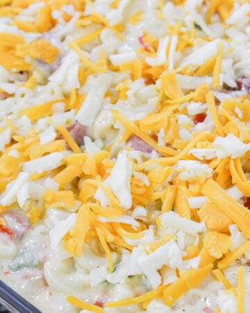 A casserole dish with macaroni and cheese sauce with andouille sausage to make a Cajun macaroni and cheese.