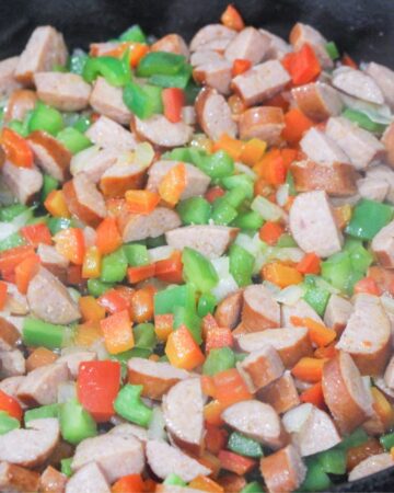 Andouille sausage with peppers to make the base for Cajun mac and cheese.