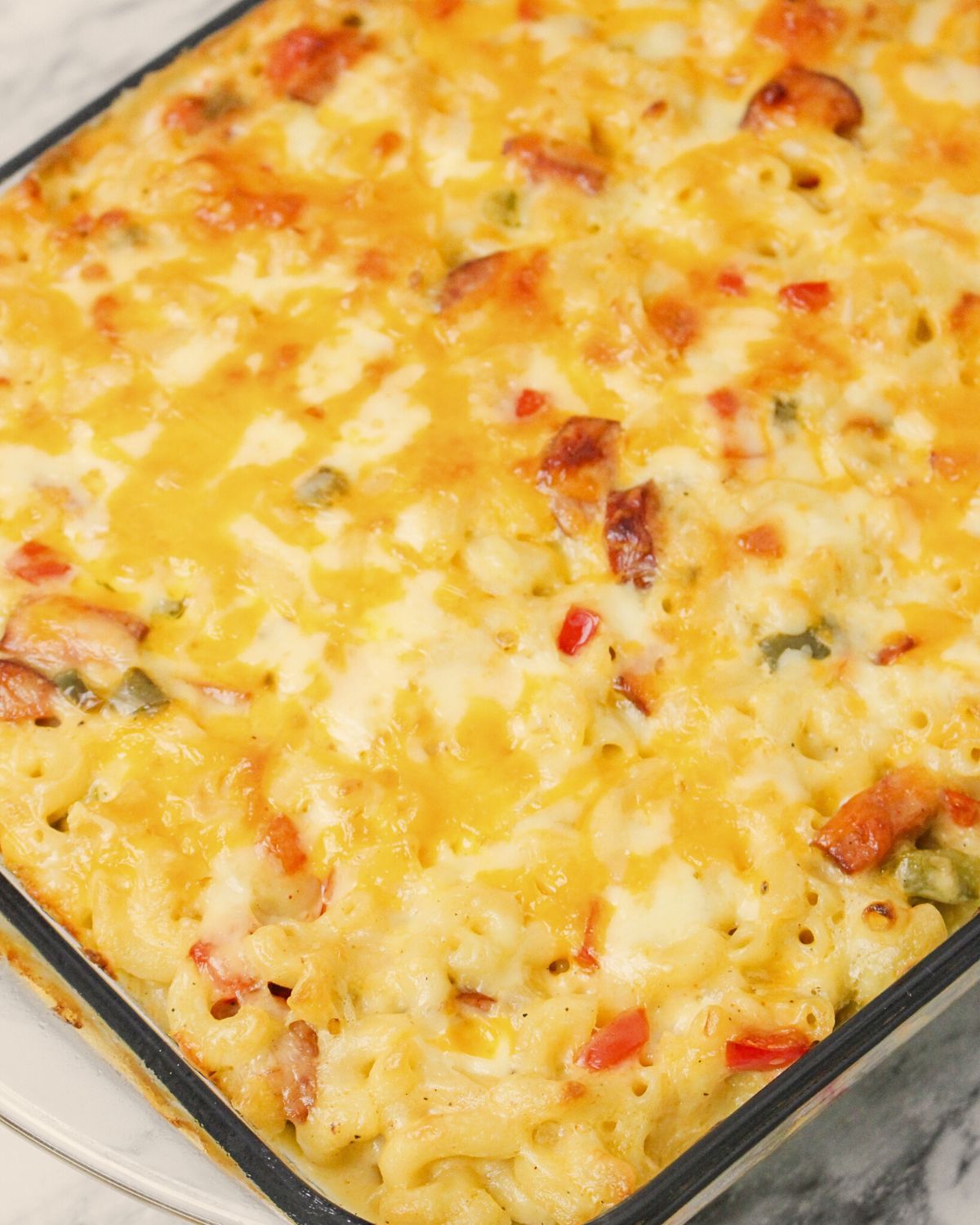 A baking dish with baked Cajun mac and cheese.