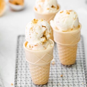 NO- Churn Cheesecake Ice cream in cones on a wire rack.