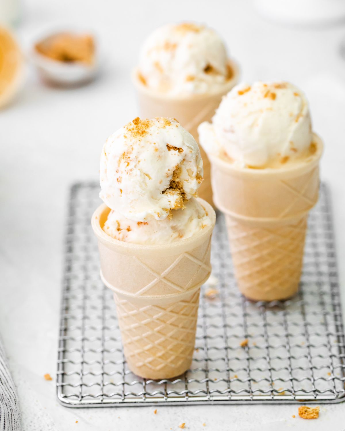 NO- Churn Cheesecake Ice cream in cones on a wire rack.