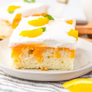 A slice of orange creamsicle poke cake.