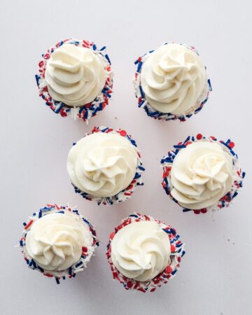 Waffle cones with patriotic sprinkles and cheesecake filling.