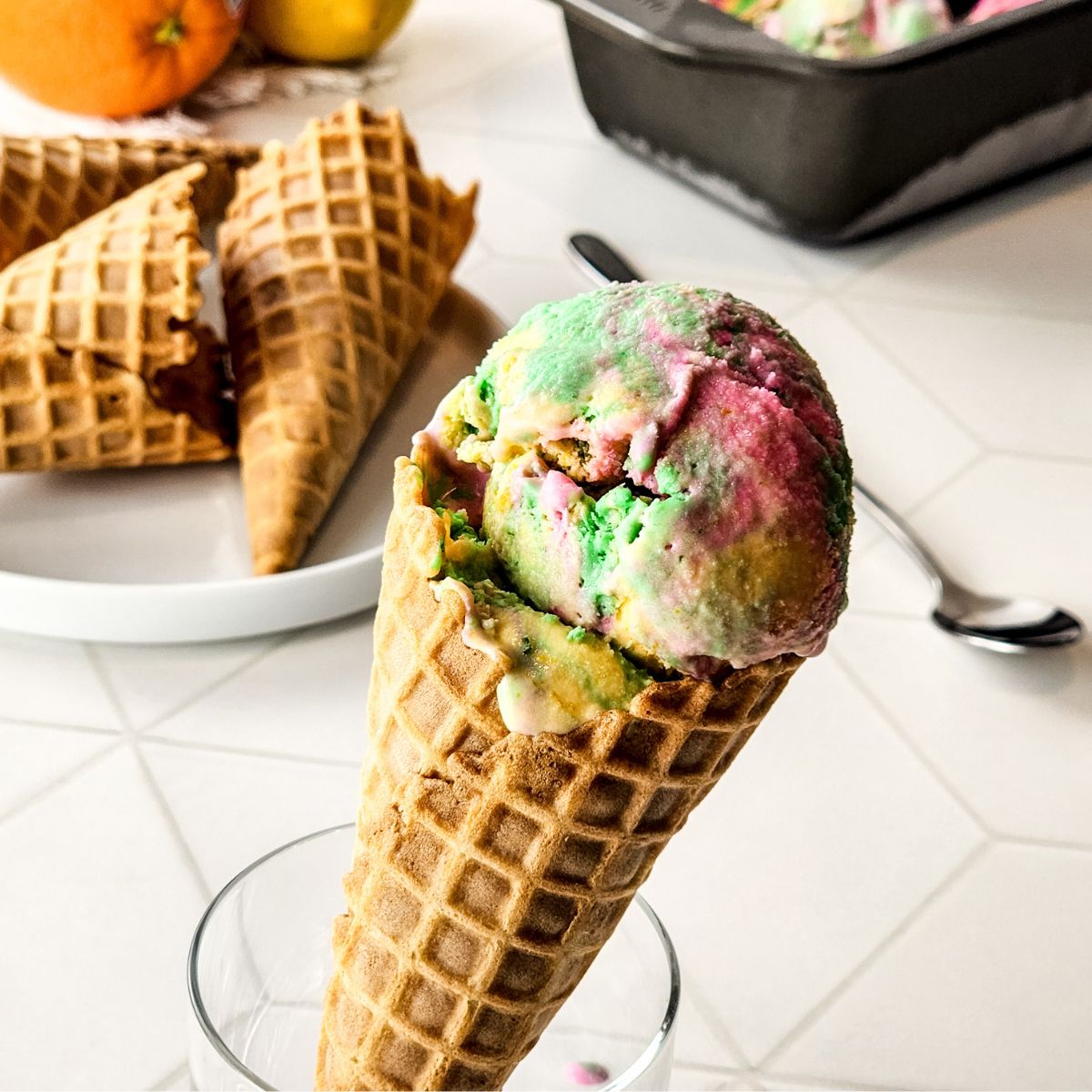 Homemade rainbow sherbet in a waffle cone.