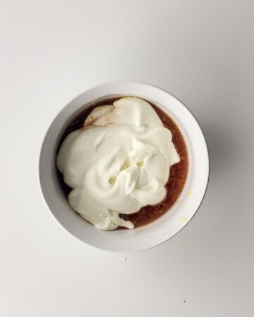 A bowl of whipped cream and juice concentrate to make rainbow sherbet. 