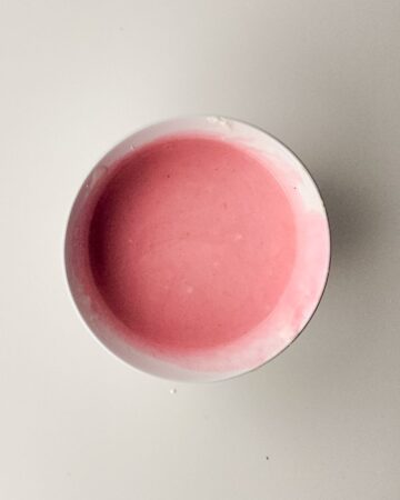 A bowl of concentrated juice and whipped cream to make rainbow sherbet ice cream