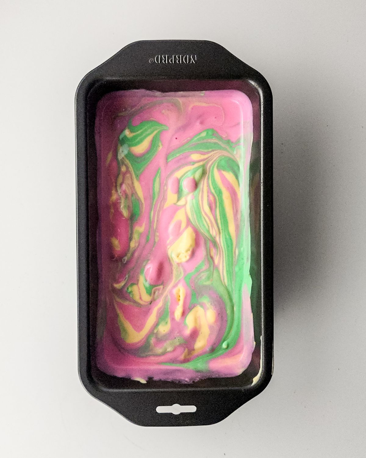 Rainbow Sherbert in a loaf pan ready to go into the freezer. 
