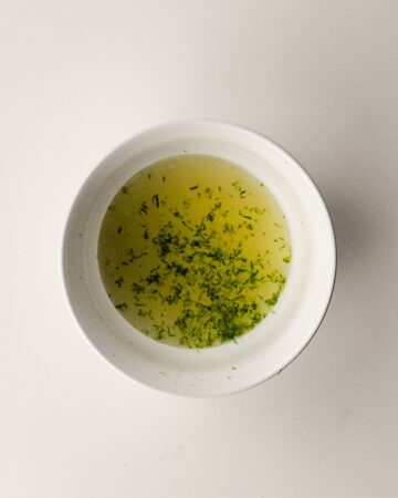 A bowl with juice concentrate and zest to make rainbow sherbet. 
