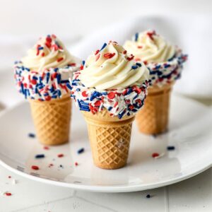 Red white and blue sprinkles on cheesecake waffle cones.