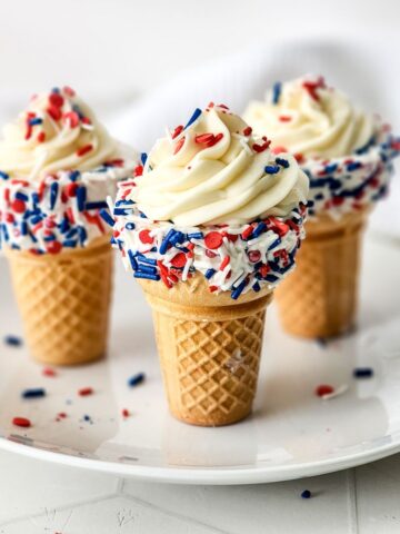 Red white and blue sprinkles on cheesecake waffle cones.