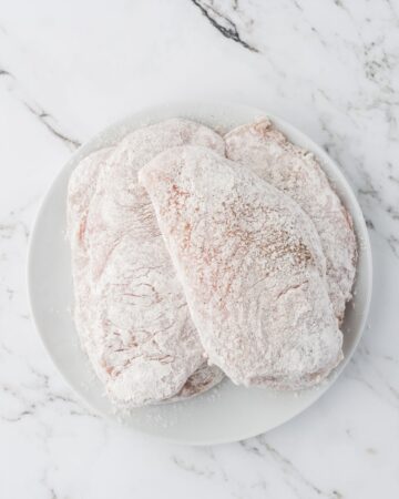 Seasoned chicken cutlets with all purpose flour.