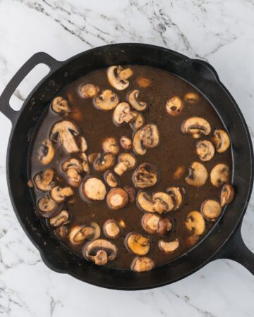 A cast iron pan with mushrooms and marsala wine.