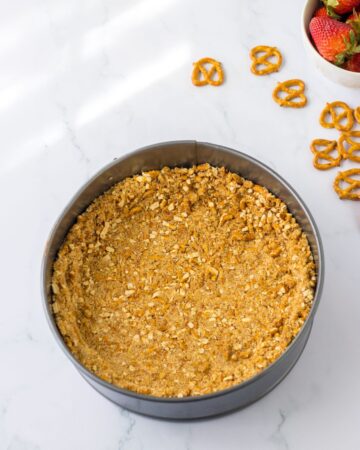 A pretzel crushed in a springform pan. 