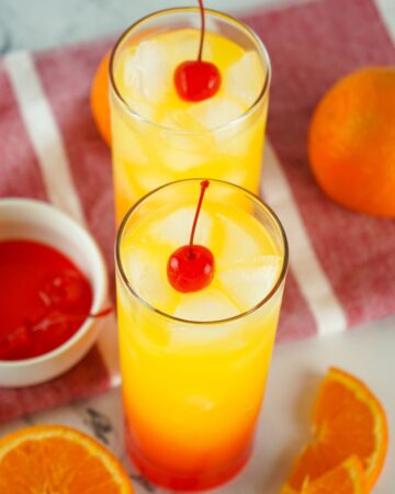 Tequila Sunrise topped with a cherry. 
