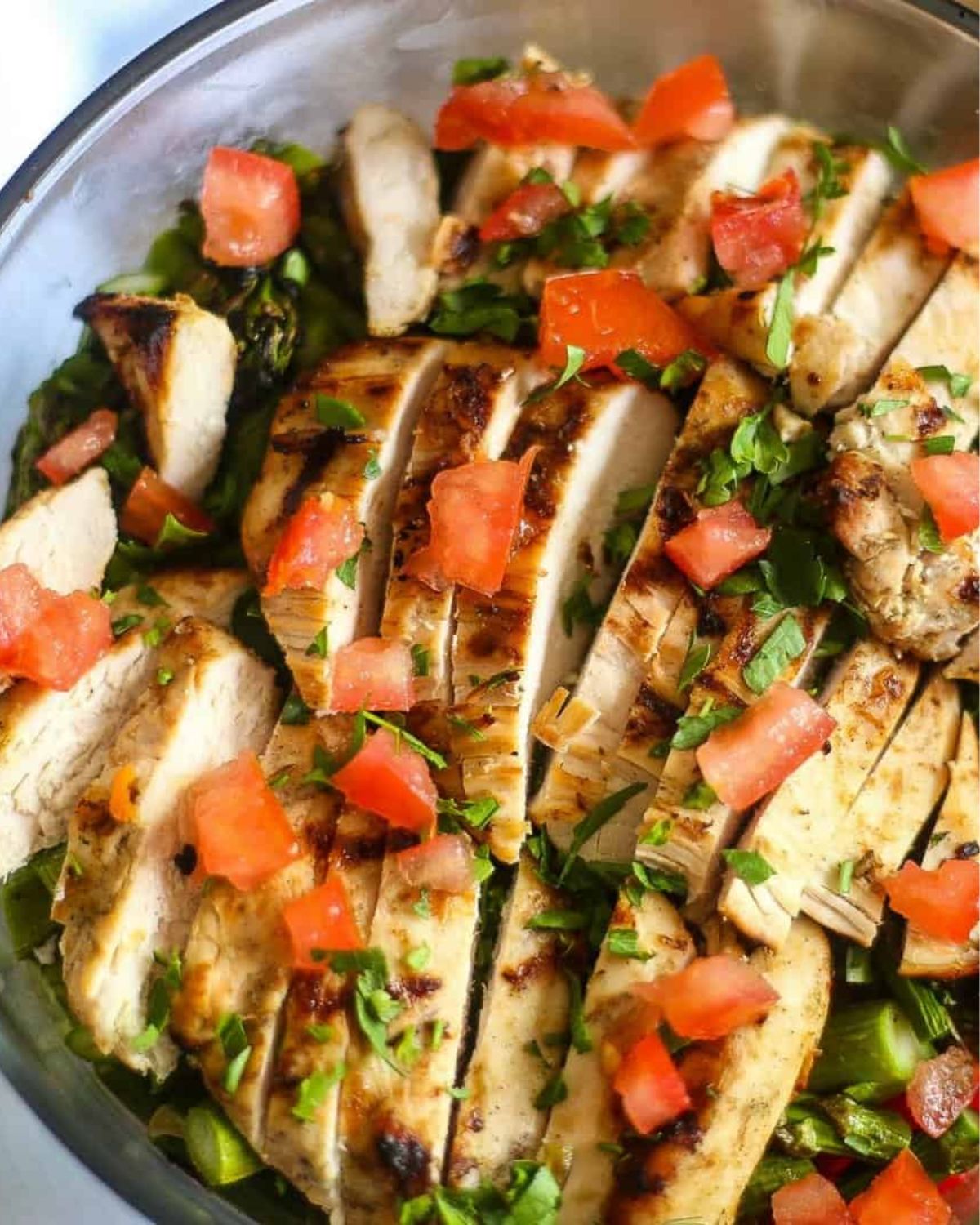 Chicken asparagus salad in a glass bowl.