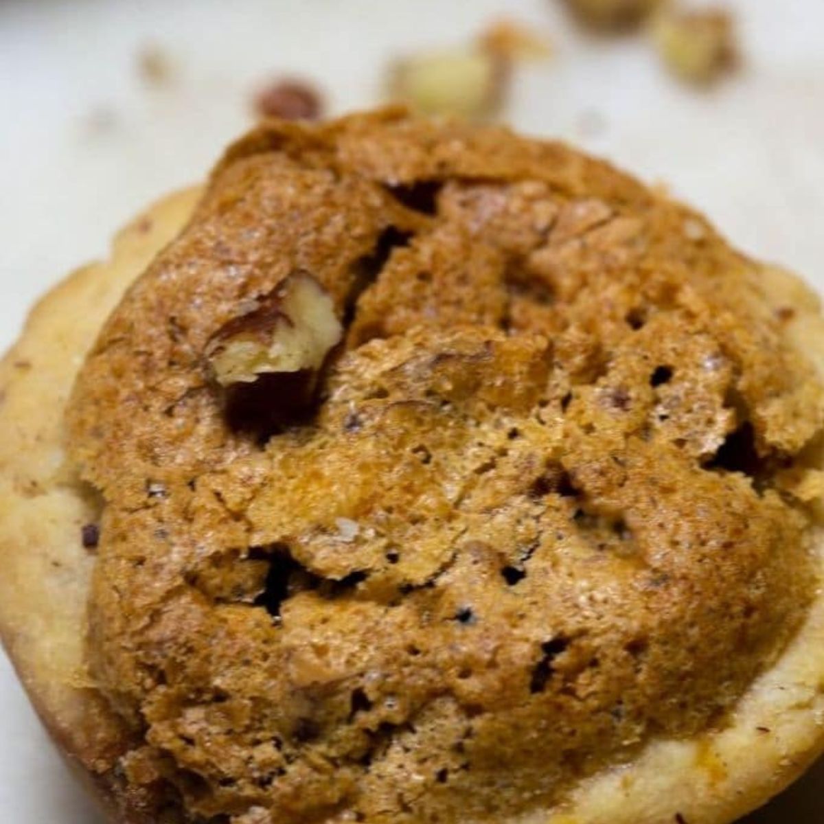 A pecan tart cookie on a plate.