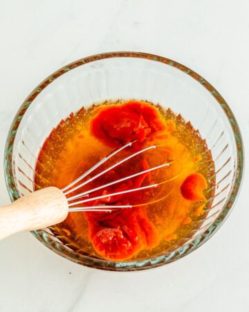 A glass bowl of the ingredients to make orange chicken. 