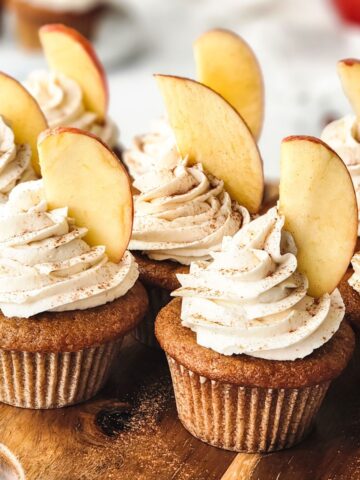 Apple cider cupcakes with an apple cider buttercream topped with apple slice.