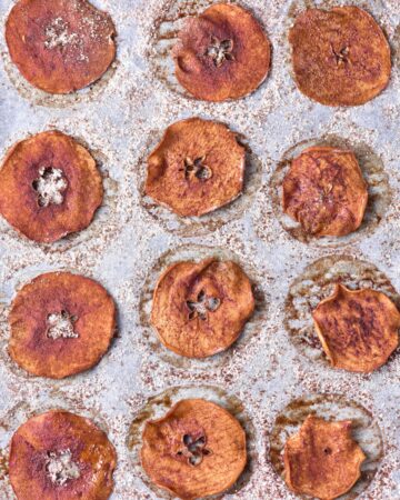 Apple chips that have been baked and sprinkled with cinnamon sugar.