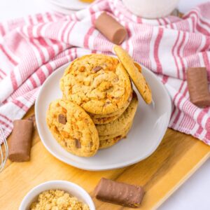 Butterfinger cookies stacked on a plate.
