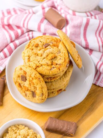 Butterfinger cookies stacked on a plate.