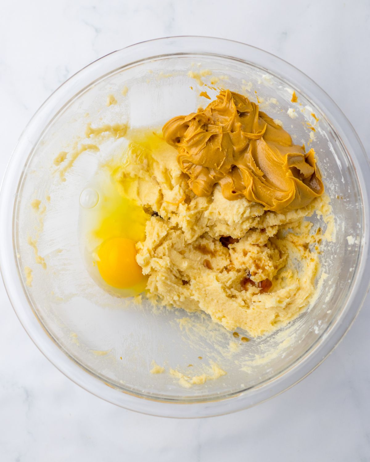 A glass bowl with cookie dough batter to make butterfinger cookies. 