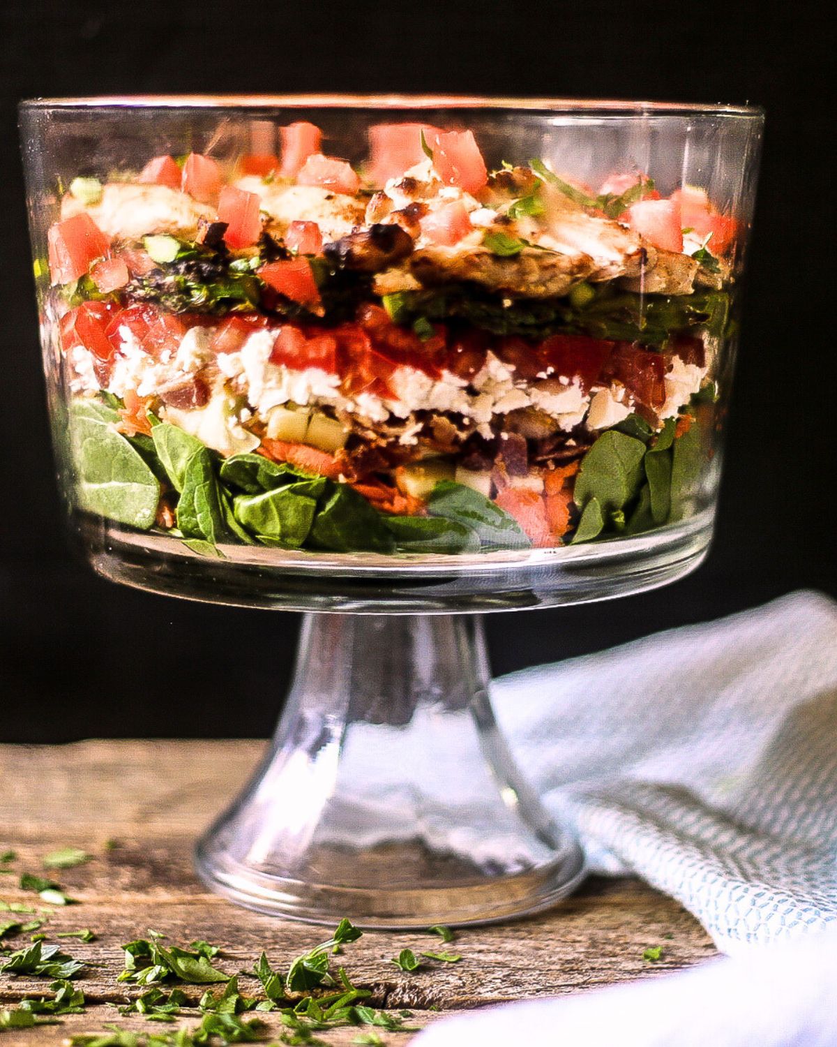 A large glass bowl with an asparagus chicken salad.
