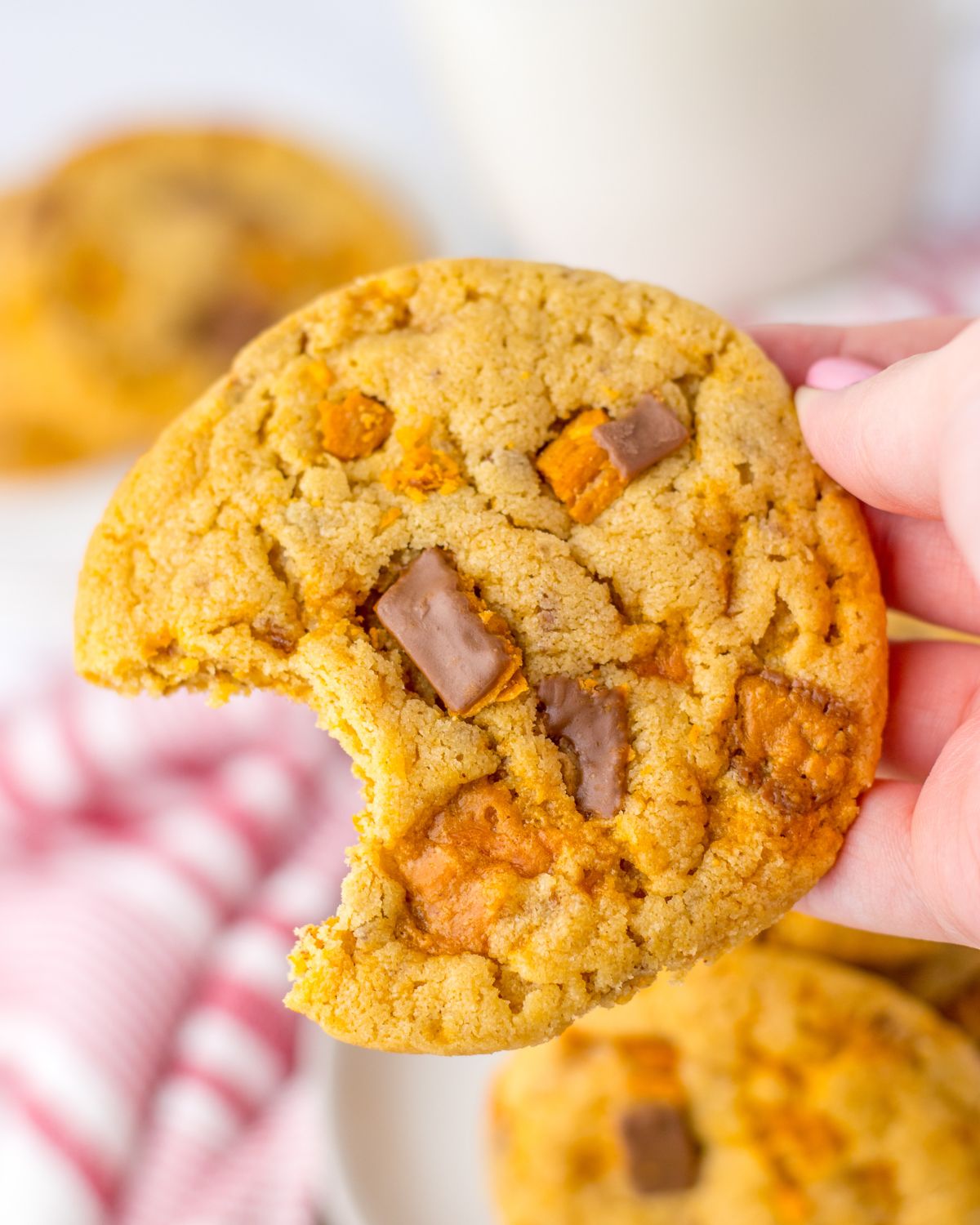 A butterfinger cookie with a bite out of the cookie. 