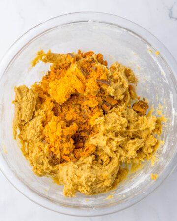A glass bowl with cookie batter to make butterfinger cookies. 