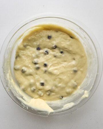 A glass bowl of blueberry lemon ingredients to make a loaf.