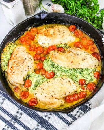 Ricotta Spinach Chicken Breasts in a cast iron pan.