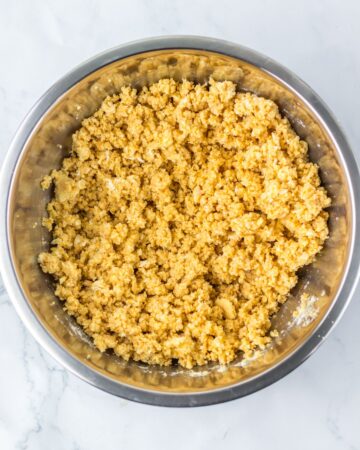 A bowl of crushed vanilla sandwich cookies and cream cheese to make truffles.