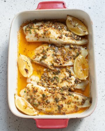Baked lemon butter sauce over tilapia fillets.