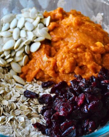 Dry ingredients mixed with pumpkin puree, dried cranberries, and pumpkin seeds to make pumpkin oat bars.