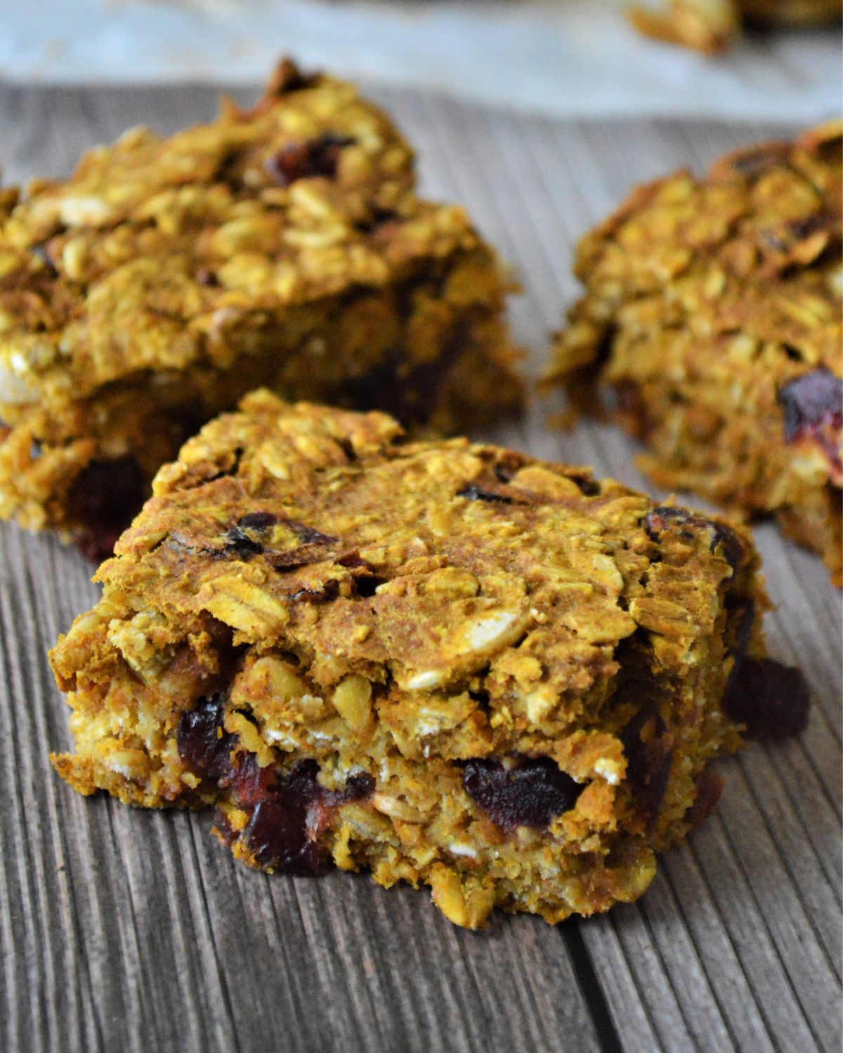 Sliced cranberry pumpkin oat bars sliced on a baking tray.