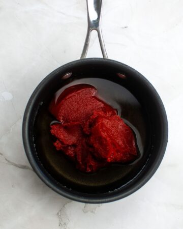 A large pot with the ingredients to make homemade tomato ketchup. 