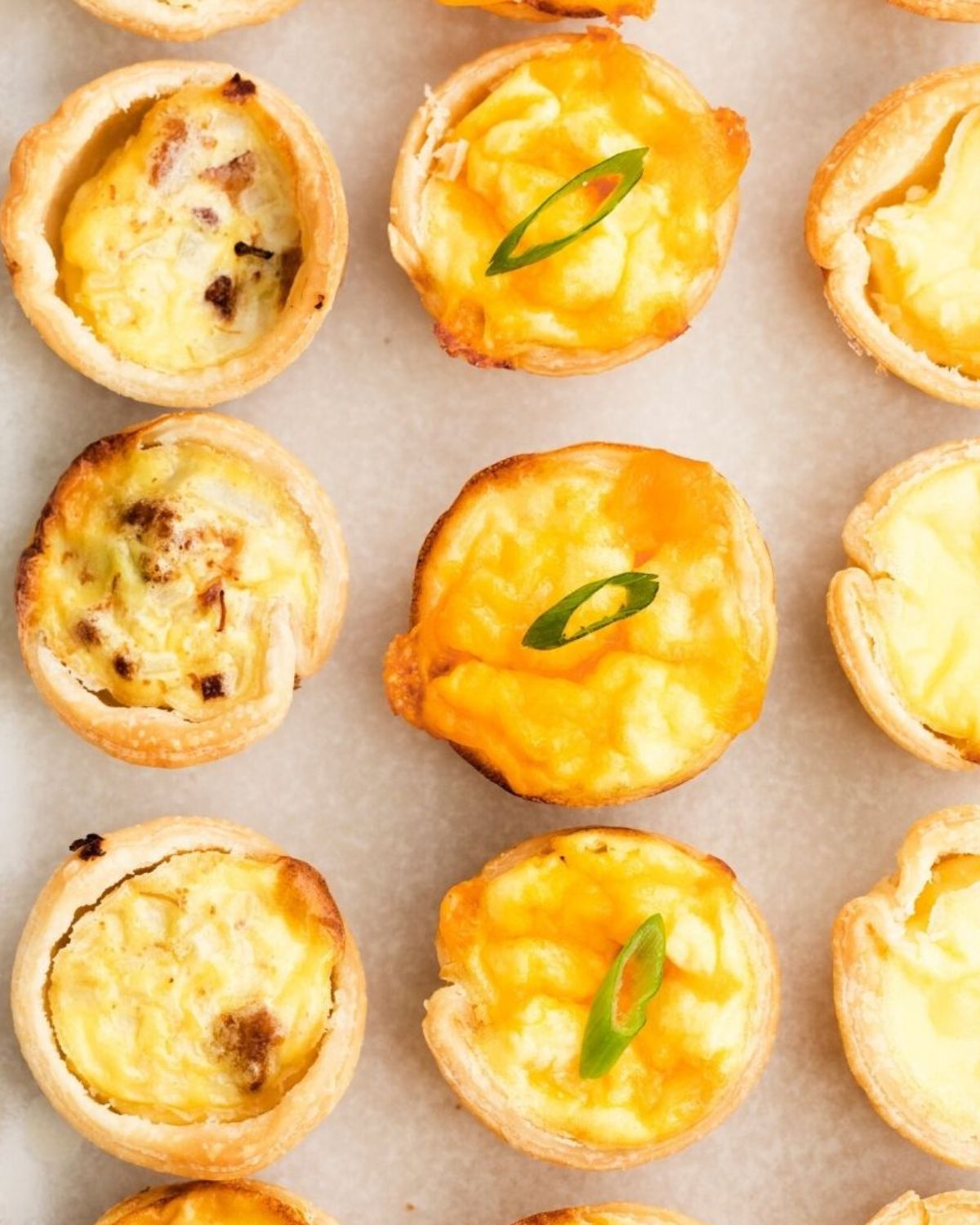 Mini quiche in premade pie crust circles on a plate.