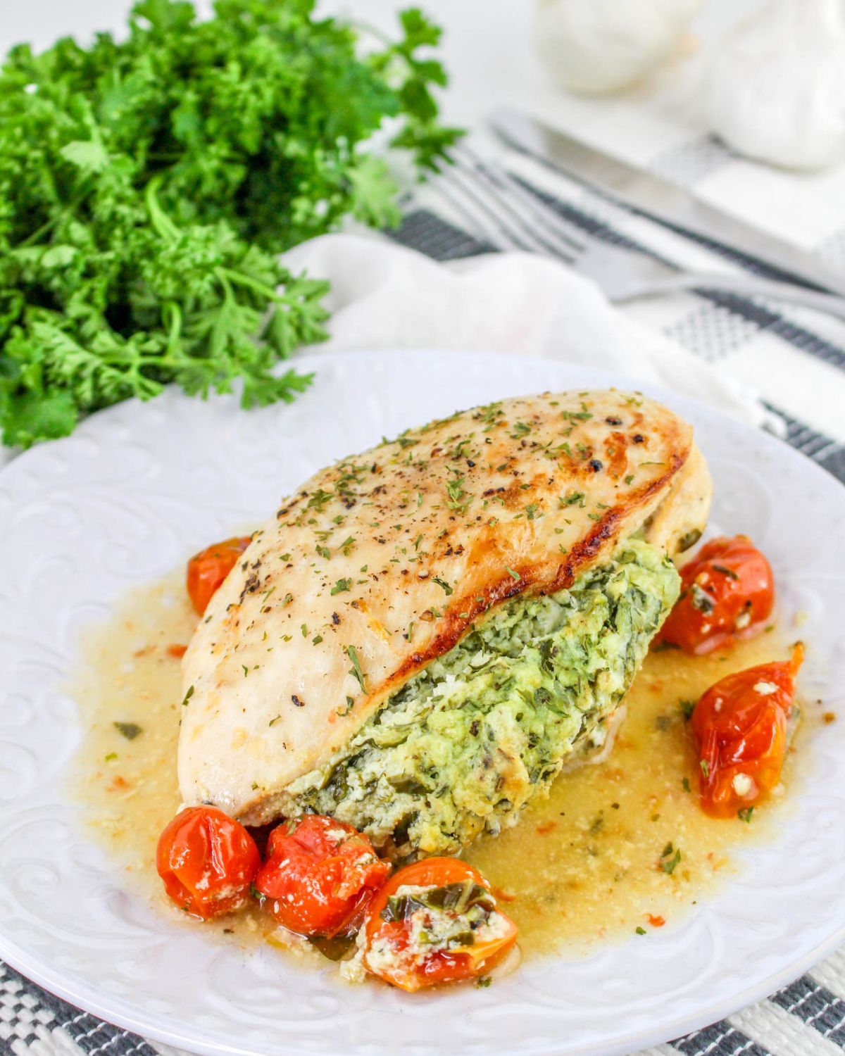 A plate of boneless chicken breasts stuffed with spinach ricotta cheese.
