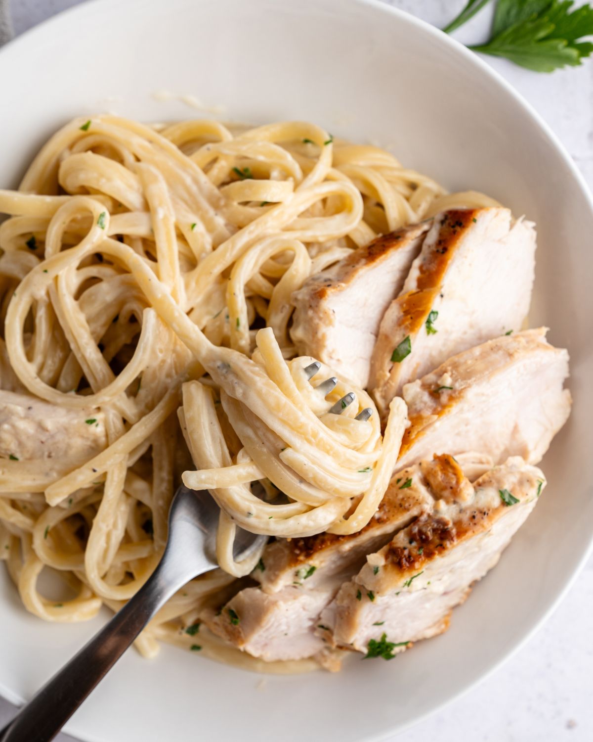 Linguine with an alfredo sauce and sliced chicken.