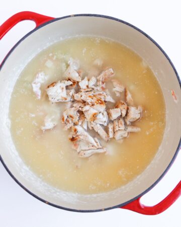 Creamy chicken gnocchi soup with fresh cooked sliced chicken in the dutch oven.