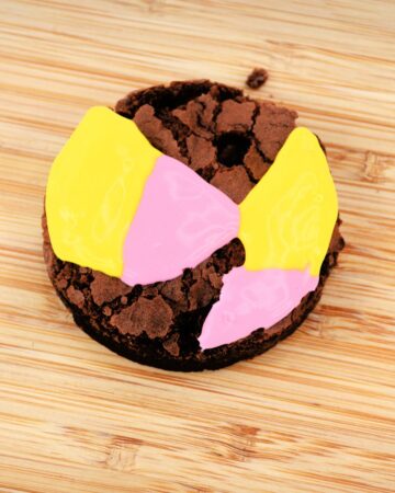 Preparing a Halloween Sally Brownie with icing that is yellow and pink to make a scary Halloween treat.