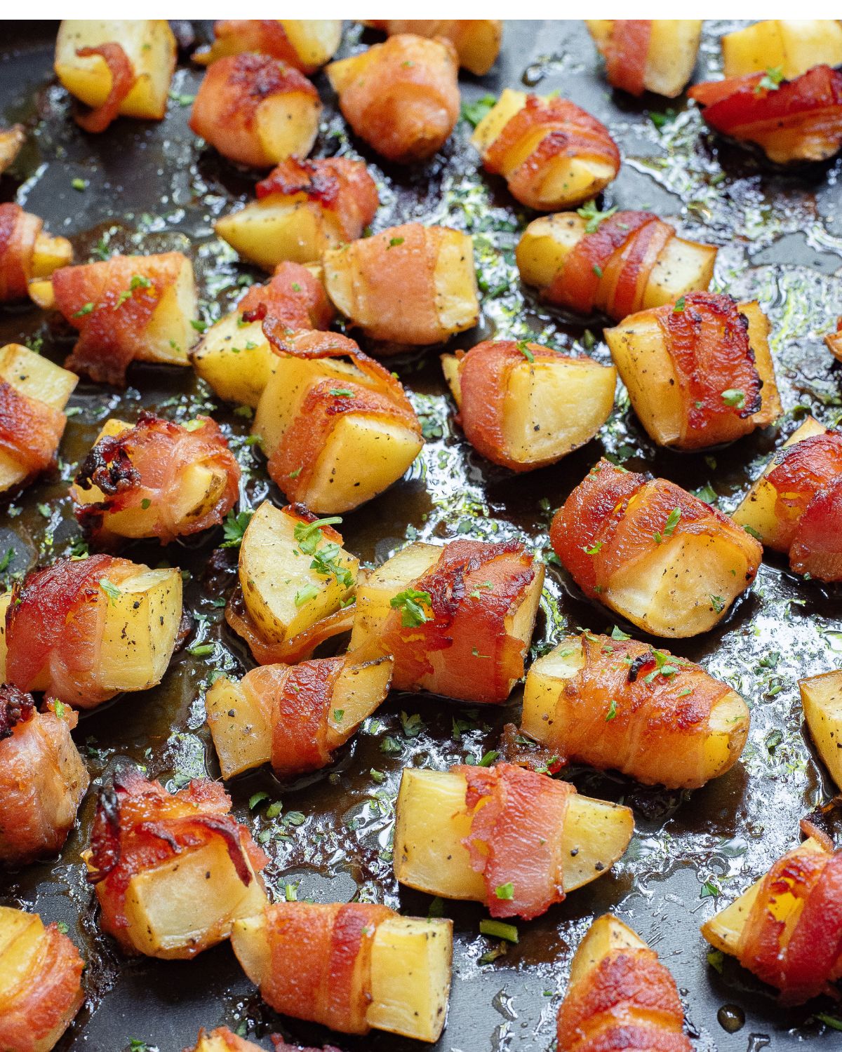 Sliced of potato on a baking sheet wrapped in bacon and baked.