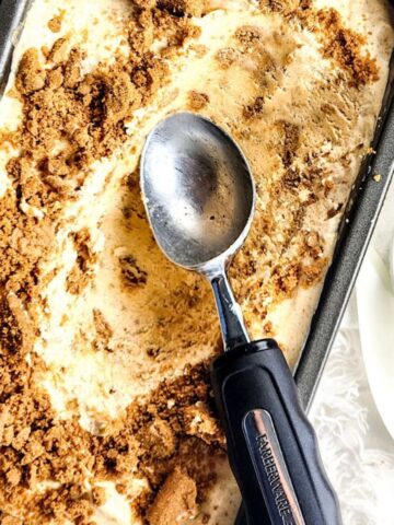 A loaf pan with pumpkin ice cream with a Biscoff cookie crumble.
